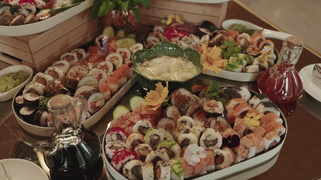 colorful sushi platters with dips and flowers arranged for upscale dining