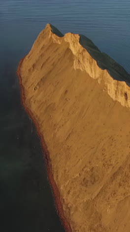 aerial view of a coastal cliff and sandy island