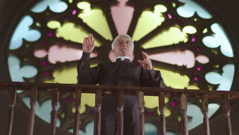 senior priest preaching sermon in lutheran church