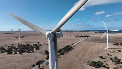 orbiting drone shot of spinning wind turbine