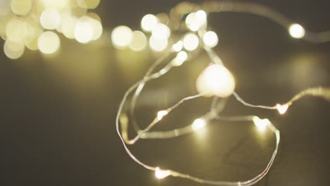 Video-of-close-up-of-christmas-fairy-lights-on-black-background