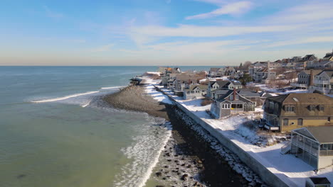 aerial forward motion flight parallel to snowy seawall