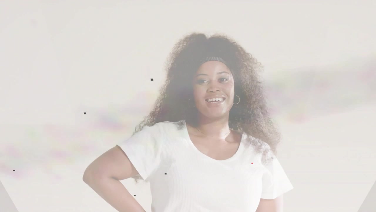 Female model standing holding hips while camera rolling, softening into laughter for ads dust