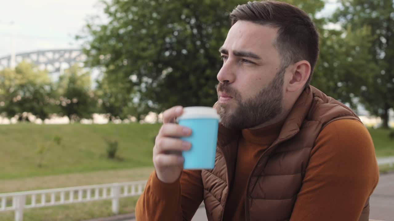 Man Drinking Coffee near Park
