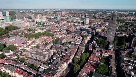 aerial drone shot flying high over residential houses and roads along the historic city center of utrecht in the netherlands on a sunny day