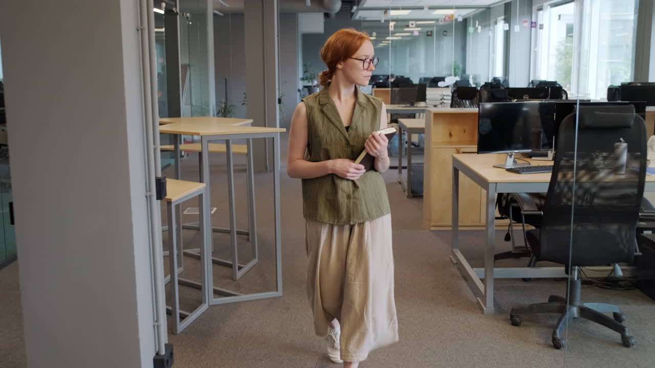 Young Office Worker Walking Along Office