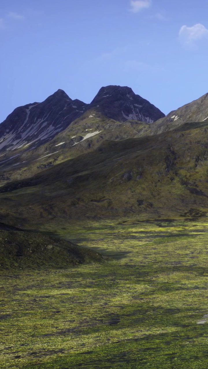 Montagne si ergono sopra un paesaggio verde sotto un cielo sereno di giorno