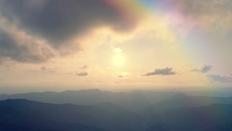 the flight above the mountain on the sunny background. hyperlapse