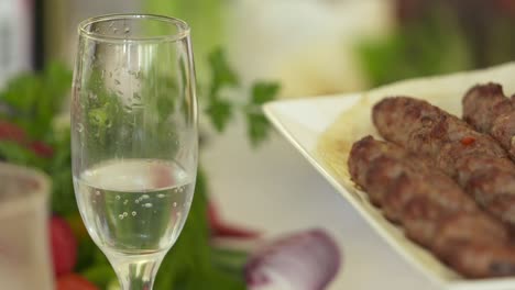 dinner table served with lula kebabs and fresh vegetables