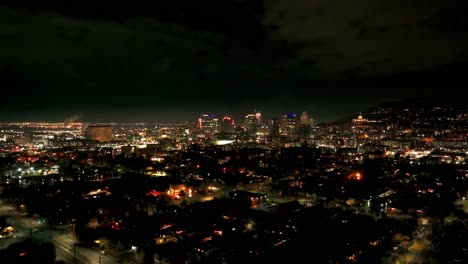 Panning-to-the-left-drone-shot-of-downtown-Salt-Lake-City-skyline-at-nighttime