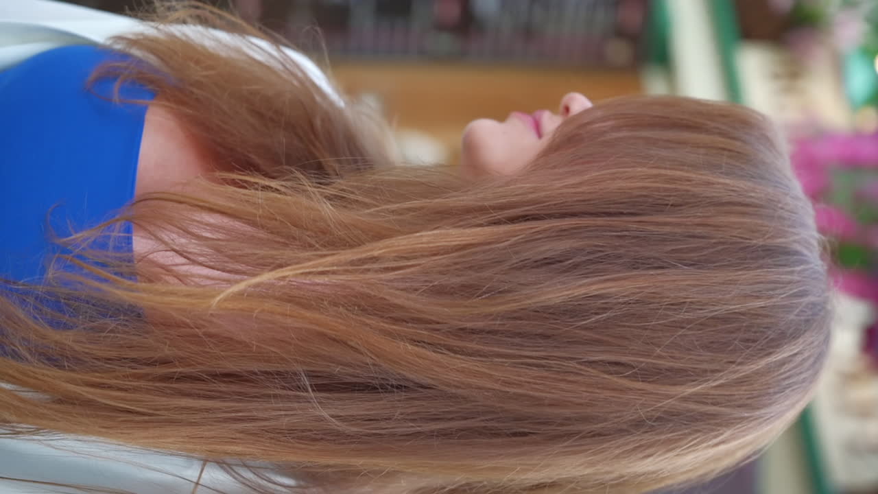 Brunette woman smiling in front of an outdoor cafe. Vertical