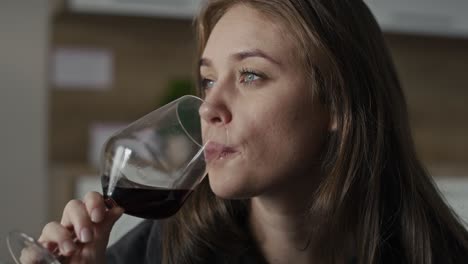 Sad-caucasian-woman-with-problems-drinking-red-wine-at-home.