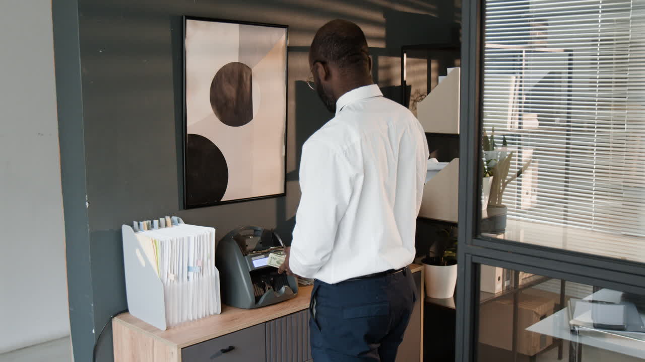 Businessman Counting Money in Modern Office
