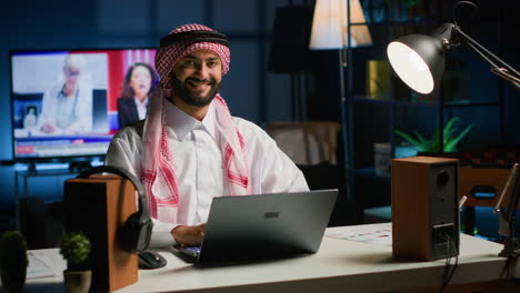 middle eastern man typing on laptop