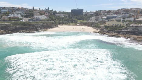 Beachgoers-Enjoying-Cool-Ocean-Waves-In-Summer