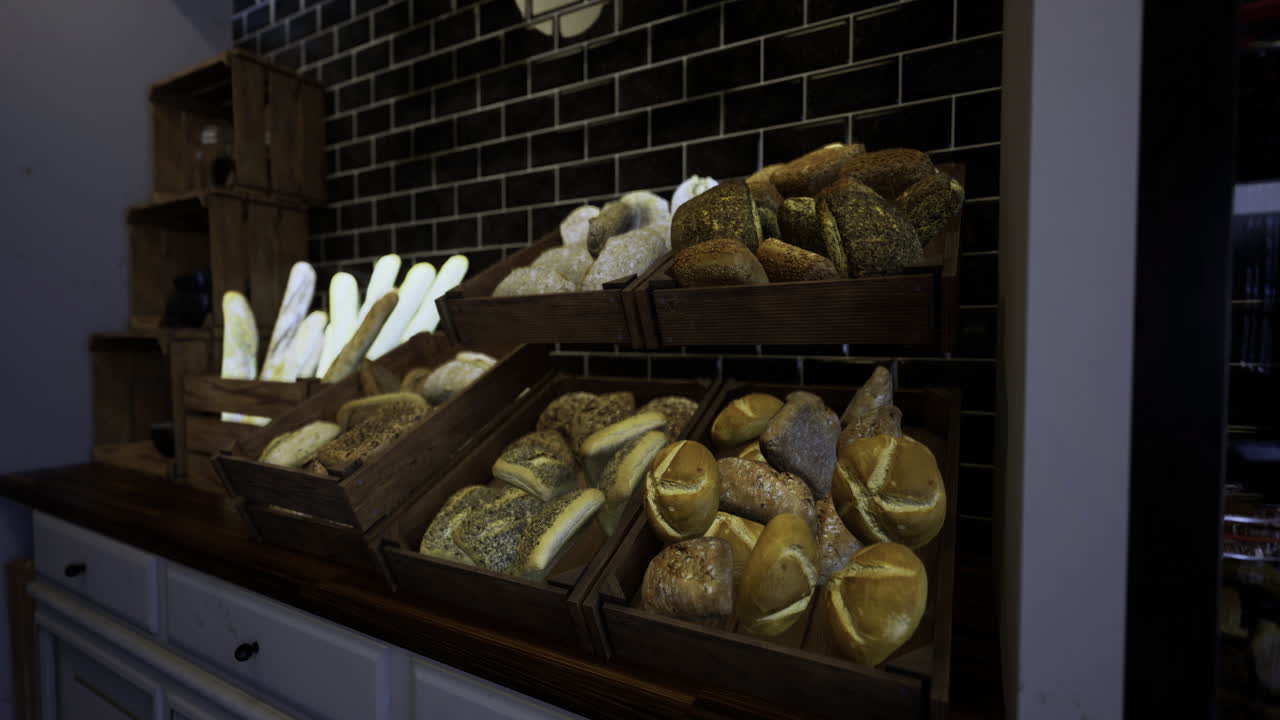 Artisan breads displayed in rustic wooden crates at a bakery