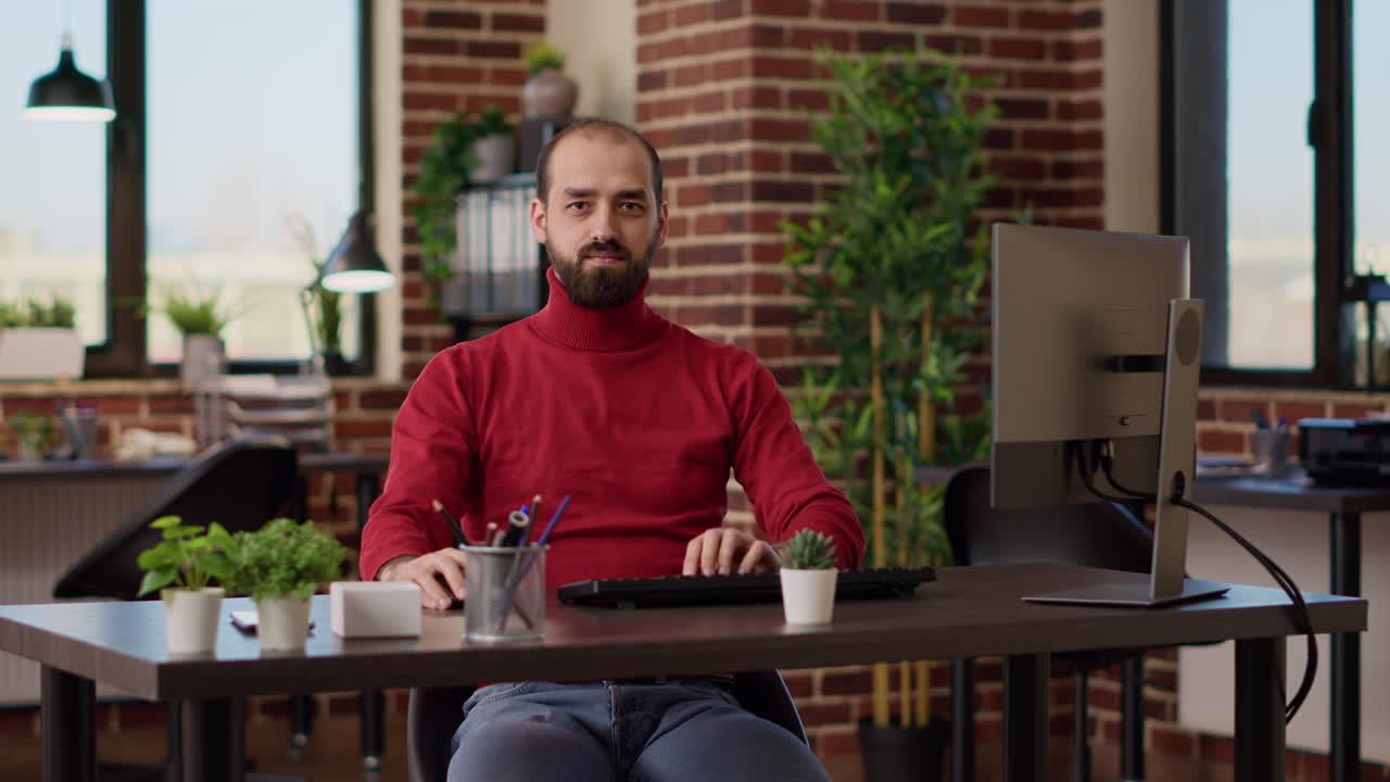 Portrait of businessman sitting at desk and preparing to work