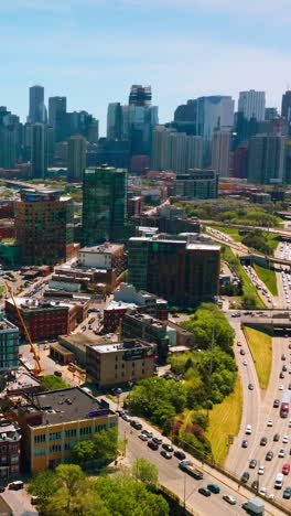broad multi-lane road going through the busy city. bright and diverse architecture of chicago at the backdrop of skyscrapers. vertical video