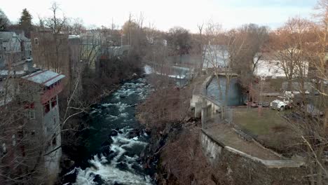 wappingers creek is shown flowing near downtown wappingers falls in this 4k aerial footage