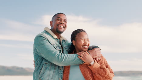 Couple,-beach-and-pointing-with-smile