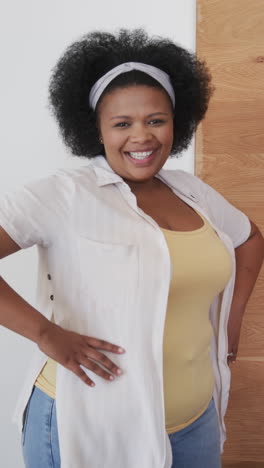 vertical video portrait of happy plus size african american woman smiling at home