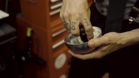 Barber-Mixing-A-Shaving-Cream-For-His-Client-In-The-Barber-Shop---close-up