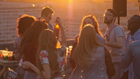 group of friends enjoying a party on a terrace at sunset 2