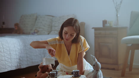 a girl playing with dolls in her room