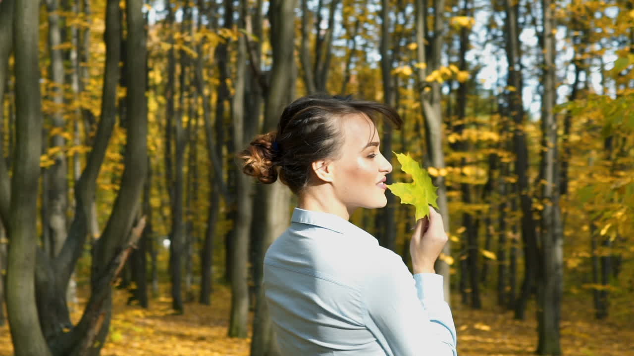 Elegant woman walking in a park. Beautiful elegant woman walking in a park in autumn , Fall concept
