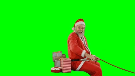 Santa-claus-with-gift-box-riding-on-green-screen
