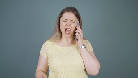 angry young woman talking on the phone.