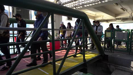 crowd or group of people crossing a bridge