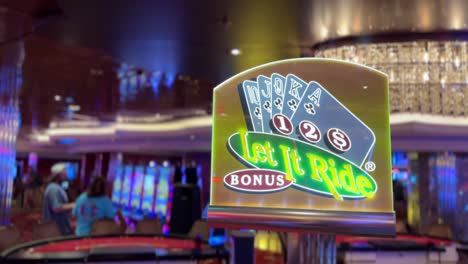 Casino-cards-table-Let-it-Ride-Bonus-poker-sign,-people-walking-by,-4K