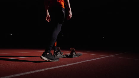 sprinter preparing to race at night