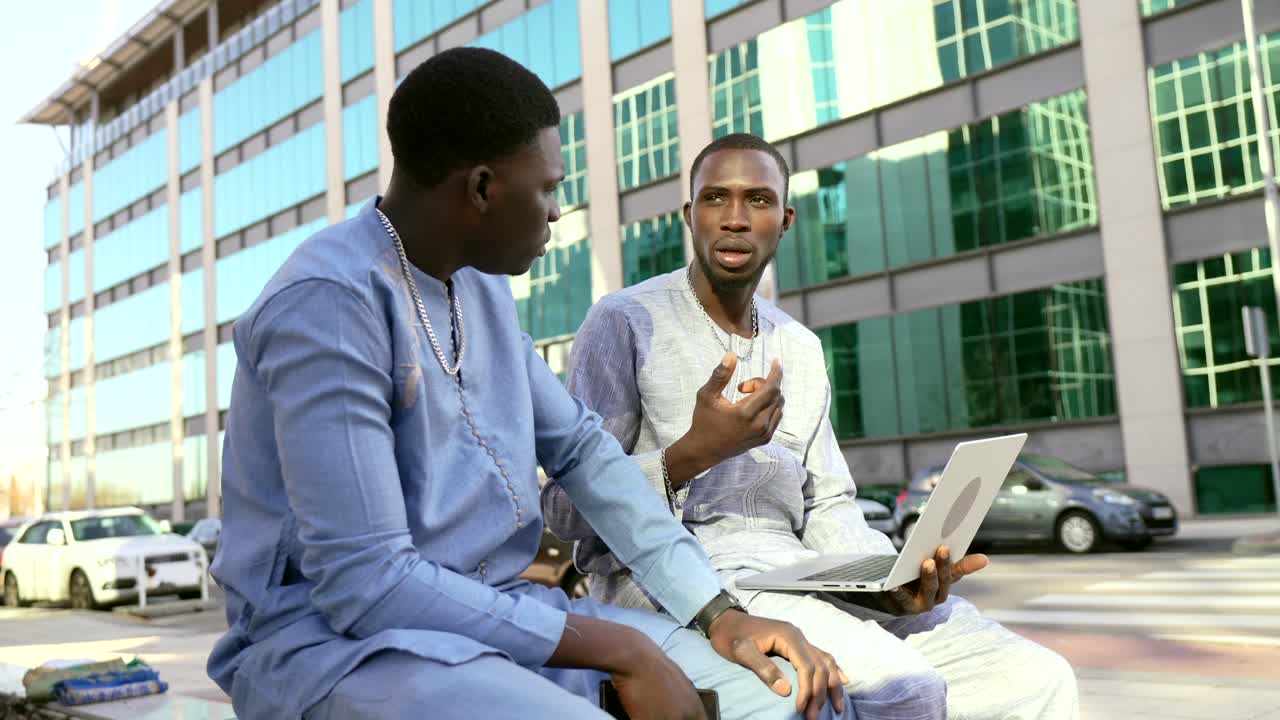 Two African men having a discussion outdoors