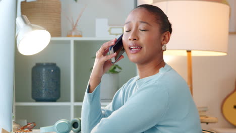 Female-freelancer-answering-phone-while-typing