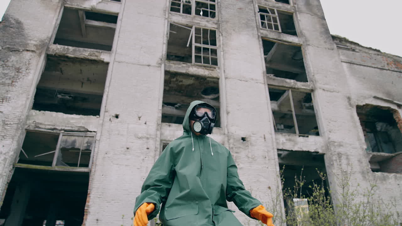 Man sitting on background of ruins. Stalker concept survivor after nuclear chemical war