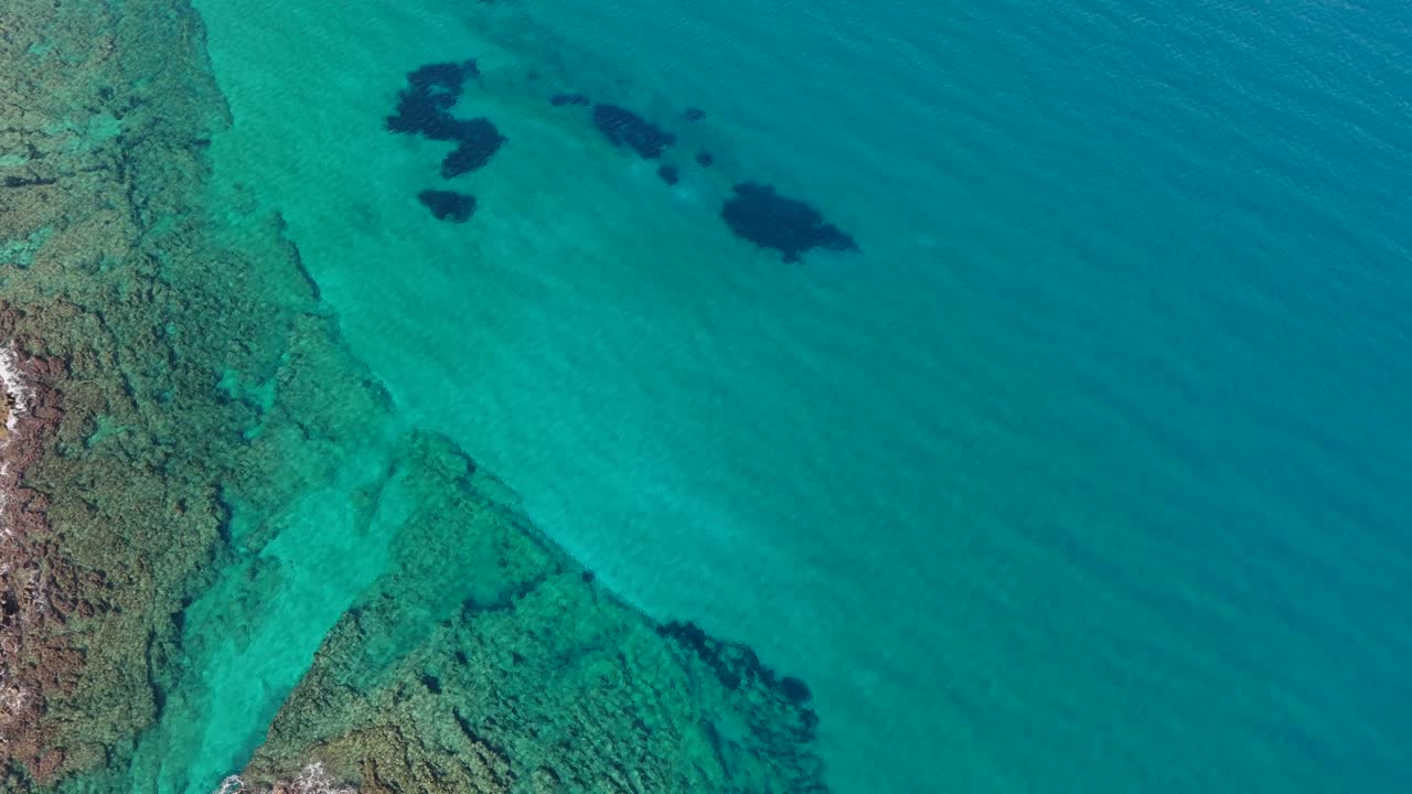 Aerial View of Crystal Clear Ocean Water with Coral Reef