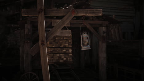rustic lantern hanging outside a weathered wooden structure at dusk
