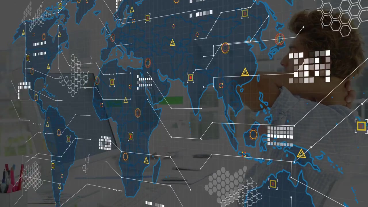 Man leaning back while monitor lighting revealing animated tech map overlaying desk monitoring data