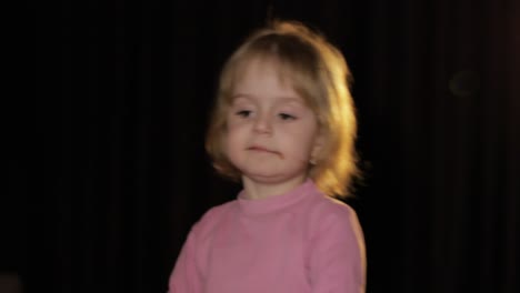 attractive child eating a huge block of chocolate. cute blonde girl