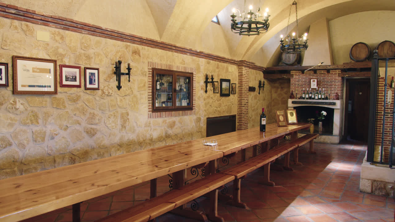 Slow motion shot of a dining room with a warm and quiet atmosphere inside a wine factory in Burgos, Spain.