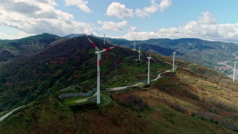 windmills by the mountains high. - aerial