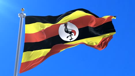 flag of uganda waving at wind in slow with blue sky, loop