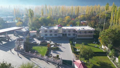 backward drone shot of baltistan resort during afternoon in pakistan