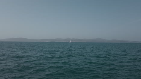 Sailboat-crosses-the-frame-as-it-sails-across-the-Adriatic-between-the-islands-of-Croatia