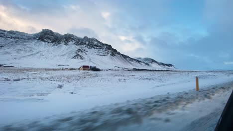 snowy mountain range viewed from driving car in iceland on hringvegur road