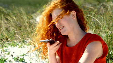 woman talking on mobile phone in the beach 4k