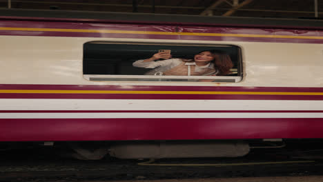woman taking a selfie from a train window