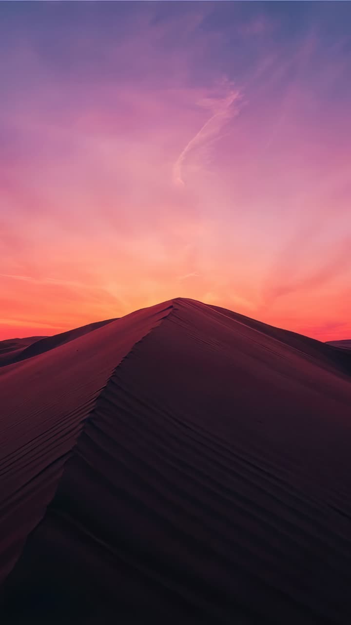 Vertical video: Moving camera showing center dune ridge at twilight, capturing ripples and sky